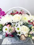 A basket of pink and white flowers