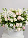 Composition with roses in a white box