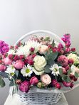 A basket of pink and white flowers