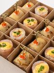 Бокс с рулетиками из креветок с семгой и блинчиками с рийетом из семги горячего копчения