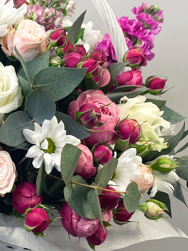 A basket of pink and white flowers