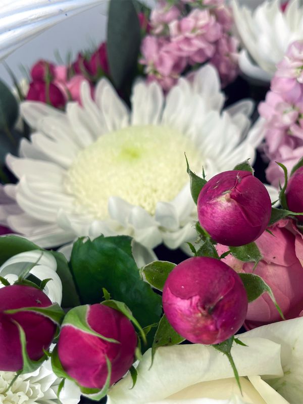 A basket of pink and white flowers