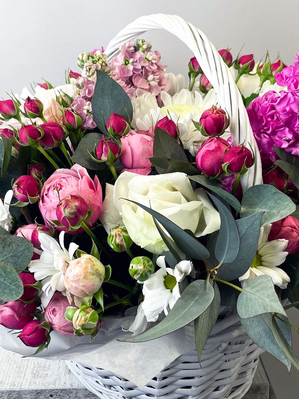 A basket of pink and white flowers