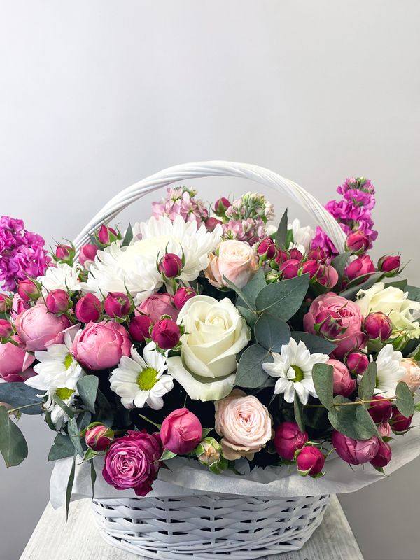 A basket of pink and white flowers