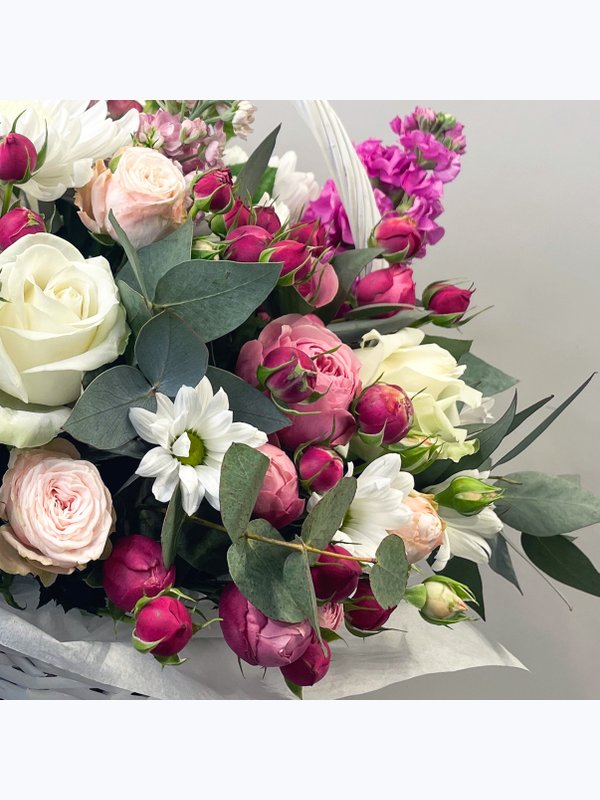 A basket of pink and white flowers