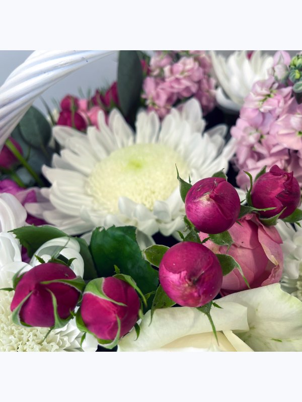 A basket of pink and white flowers