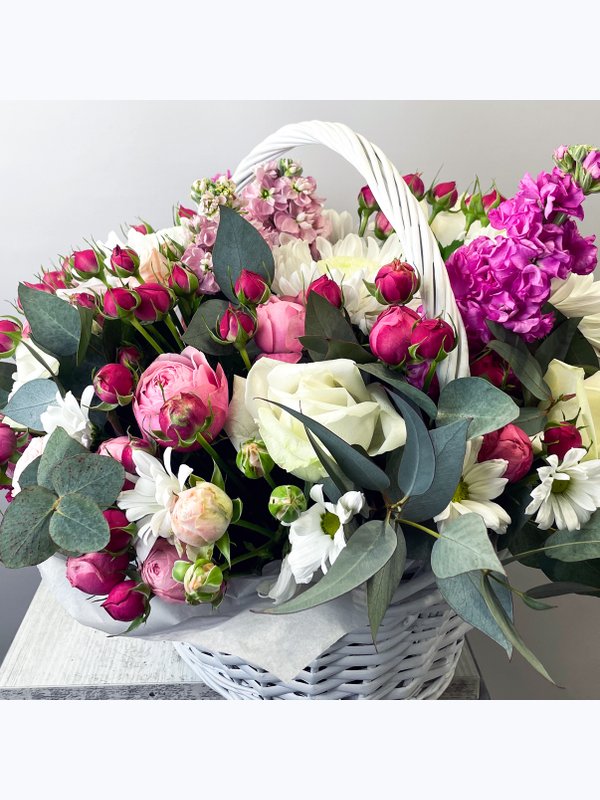 A basket of pink and white flowers