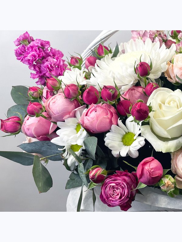 A basket of pink and white flowers
