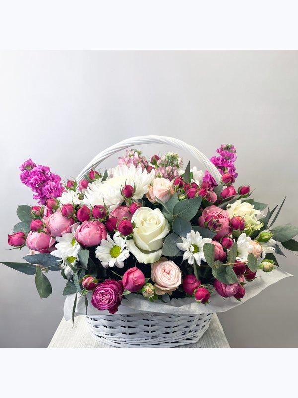 A basket of pink and white flowers